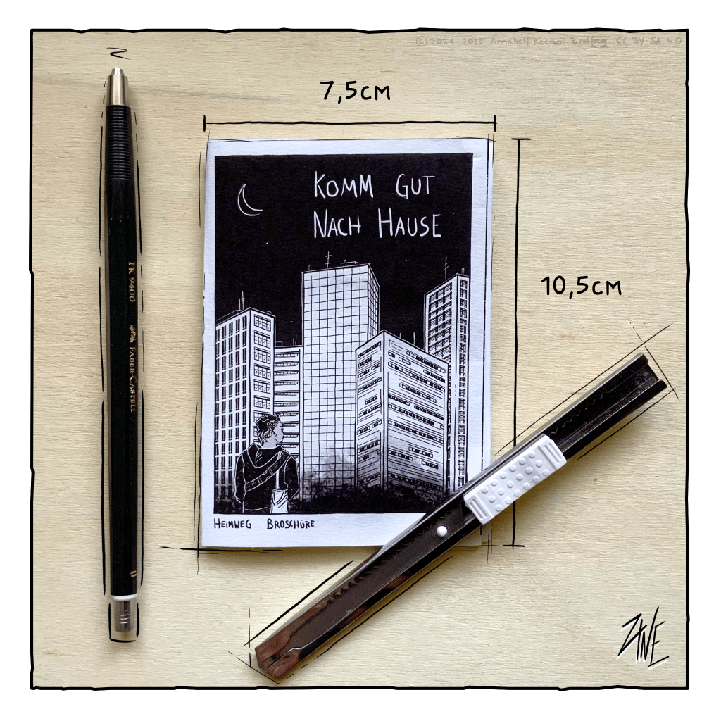 Ein gefaltetes Heftchen liegt auf einem Holzbrett. Es ist genauso groß, wie ein Stift und ein Bastelmesser, das daneben liegt. Auf dem Heftchen steht der Satz Komm gut nach Hause.